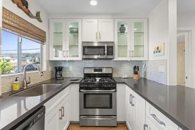 a kitchen with a stove and a microwave at Hideaway ALL Walk to the Beach Downtown AC in San Clemente