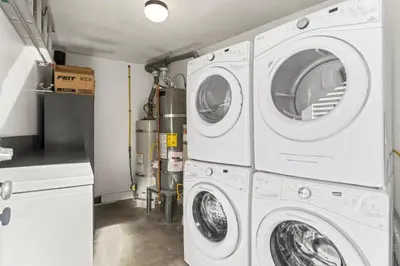 a laundry room with three washer and dryer machines at Hideaway D Walk to the beach Downtown AC in San Clemente