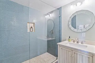 a bathroom with a shower and a sink and a mirror at Coastal Duo Steps to Wedding Venues Beach Ole Hanson Casino in San Clemente