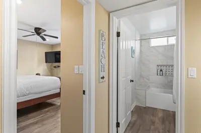 a bedroom with a bed and a bathroom with a tub at Bright 3BR Beach Condo Near Casino and Ole Hanson in San Clemente