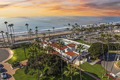an aerial view of a resort with palm trees and the ocean at Bright 3BR Beach Condo Near Casino and Ole Hanson in San Clemente