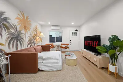 a living room with a couch and a flat screen tv at Modern 2BR in Prime Location with Board Games in San Diego