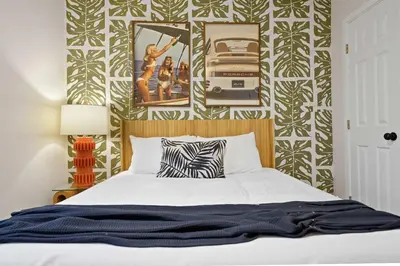 a bedroom with a bed with a black and white wallpaper at Modern 2BR in Prime Location with Board Games in San Diego