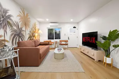 a living room with a couch and a tv at Explore North Park Chic 2br with Fire Pit Sleeps 6 in San Diego