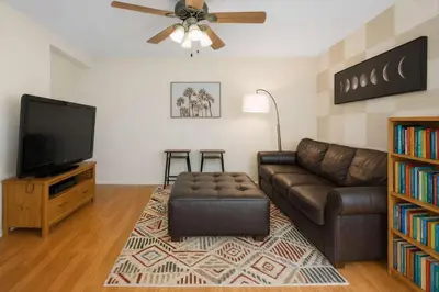 a living room with a couch and a flat screen tv at Peaceful Poolside Perfection near Wine Country in Murrieta