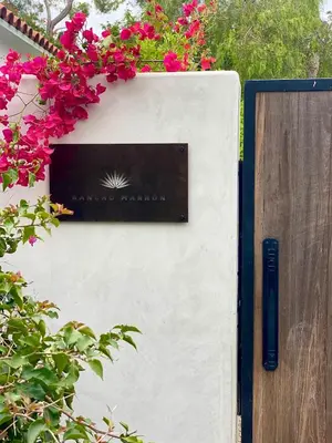 a sign on a wall with pink flowers on it at 2 Bedroom Lux Casita with Resort Amenities in Encinitas