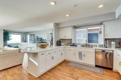 a kitchen with white cabinets and a counter top at Spectacular Ocean View! Luxe Condo in San Clemente in San Clemente