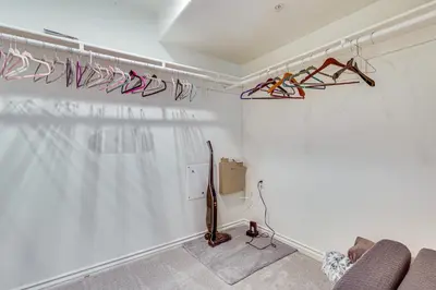 a room with a white wall with hangers at Spectacular Ocean View! Luxe Condo in San Clemente in San Clemente