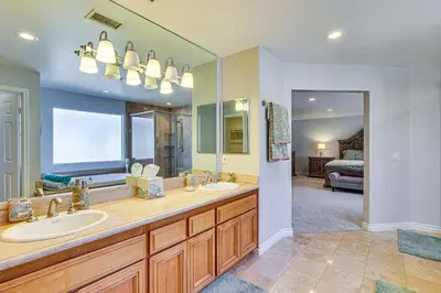 a bathroom with two sinks and a large mirror at Spectacular Ocean View! Luxe Condo in San Clemente in San Clemente