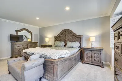 a bedroom with a bed and a chair and a mirror at Spectacular Ocean View! Luxe Condo in San Clemente in San Clemente