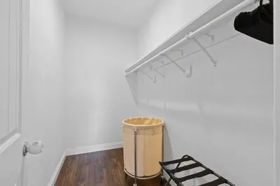 a hallway with a trash can in a white room at Spacious 3BR Home with Pool in La Mesa