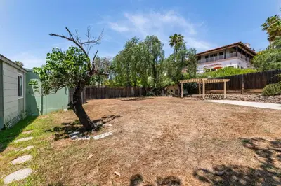 a yard with a tree and a fence at 3BR Home w/Big Yard, Close to Shops & Attractions in San Diego