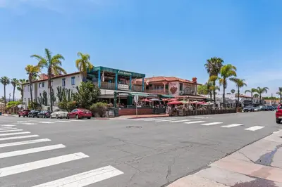 a city street with a crosswalk in front of a building at 3BR Home w/Big Yard, Close to Shops & Attractions in San Diego