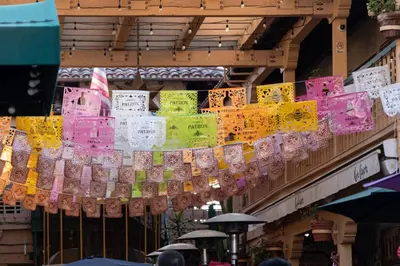a bunch of umbrellas hanging from a building at 3BR Home w/Big Yard, Close to Shops & Attractions in San Diego