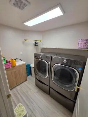 a laundry room with a washer and dryer in it at Modern Residence with Mountain Views in Escondido