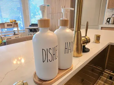 two bottles on a kitchen counter with the words dsichaha on them at Modern Residence with Mountain Views in Escondido