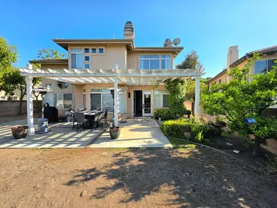 a house with a white pergola on a patio at Modern Residence with Mountain Views in Escondido