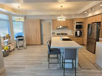 a kitchen with a table and chairs and a refrigerator at Modern Residence with Mountain Views in Escondido