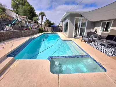 a swimming pool in front of a house at Sunny 5BEDR00MS with Pool, Zip Line, Game Room, Kid's Playhouse in San Diego