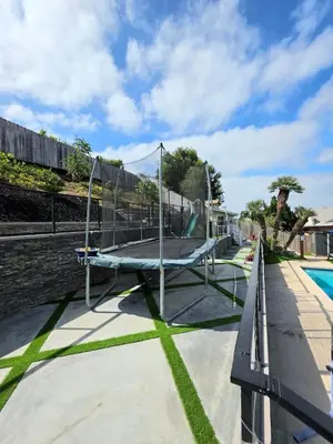 a playground with a trampoline next to a pool at Sunny 5BEDR00MS with Pool, Zip Line, Game Room, Kid's Playhouse in San Diego