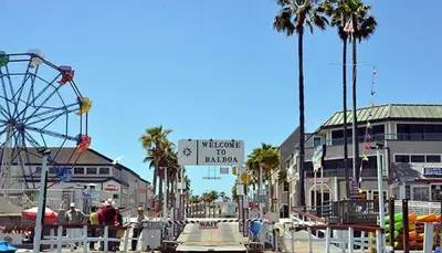an amusement park with a ferris wheel and a roller coaster at Newport Beach Lux in Newport Beach