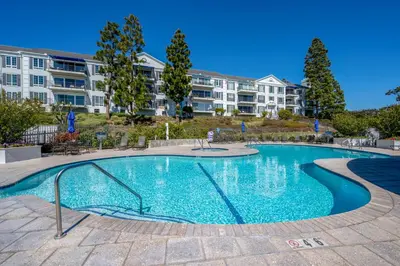 a swimming pool in front of a apartment building at Newport Beach Lux in Newport Beach