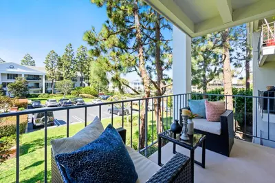 a balcony with a couch and a table at Newport Beach Lux in Newport Beach