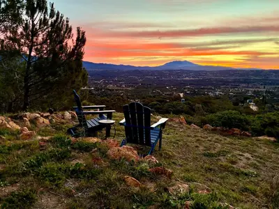 two chairs and a table sitting on top of a hill at Cahuilla Mountain Retreat in Anza