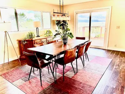 a dining room with a table and chairs on a rug at Cahuilla Mountain Retreat in Anza