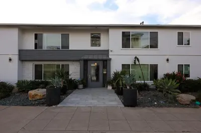 a white house with a driveway in front of it at Cozy Studio Near Balboa Park in San Diego