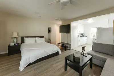 a large bedroom with a bed and a couch at Cozy Studio Near Balboa Park in San Diego