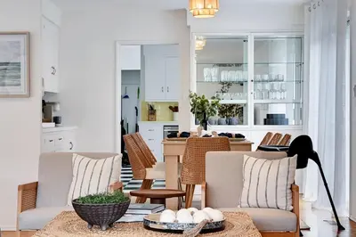 a kitchen and living room with chairs and a table at La Jolla Oasis - Spa, Sauna, Beach, Shops, UCSD in San Diego