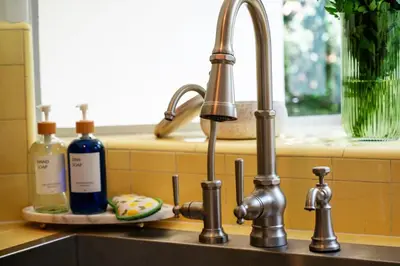 a kitchen sink with two bottles of soap on a counter at La Jolla Oasis - Spa, Sauna, Beach, Shops, UCSD in San Diego