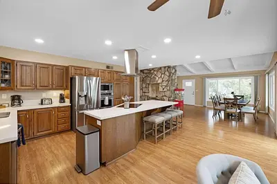 a large kitchen with wooden cabinets and a dining room at Serene 4BR La Mesa Hideaway in La Mesa