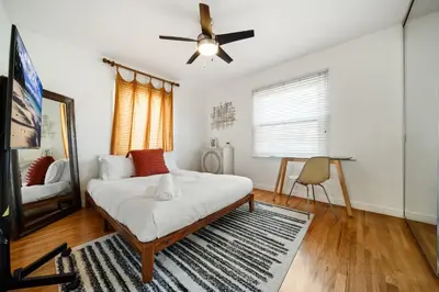 a bedroom with a bed and a ceiling fan at Little Italy Delight 3 bedroom backyard parking in San Diego