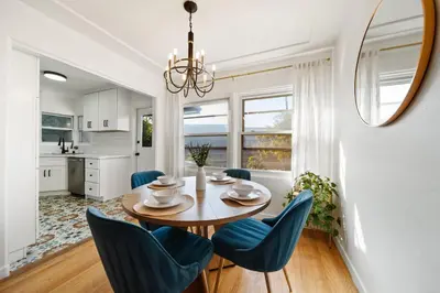 a dining room with a table and blue chairs at Little Italy Delight 3 bedroom backyard parking in San Diego