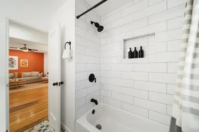 a white bathroom with a tub in a room at Little Italy Home with Parking and Backyard in San Diego