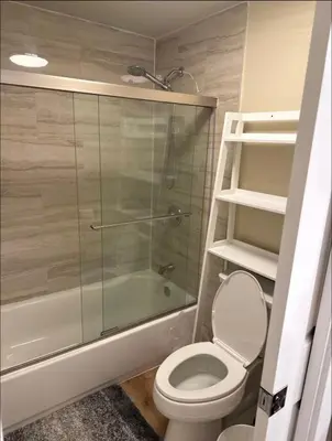 a bathroom with a toilet and a glass shower at Nice home in Irvine