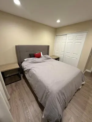 a bedroom with a bed with a red pillow on it at Nice home in Irvine
