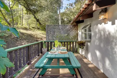 a picnic table on the deck of a house at Romantic Retreat at Rancho Las Lomas Pet Friendly