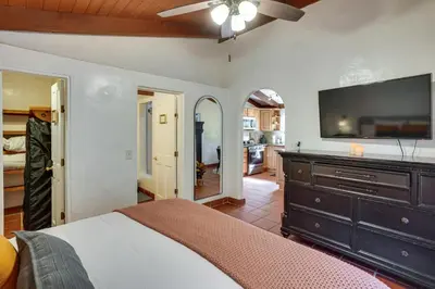 a bedroom with a bed and a flat screen tv at Creative SoCal Escape! Trabuco Canyon Casita