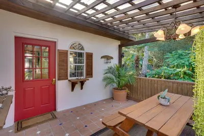 a red door on a patio with a wooden table at Creative SoCal Escape! Trabuco Canyon Casita
