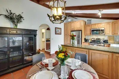 a kitchen with a table with plates and flowers on it at Creative SoCal Escape! Trabuco Canyon Casita