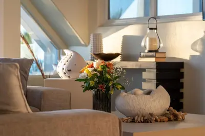 a living room with a vase of flowers on a table at Casa Azul at Mission Beach Oceanfront Getaway in San Diego