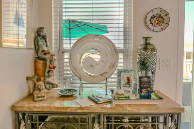 a room with a table with vases and a mirror at 2 Bdr 2 bath luxury home steps away from Mission Beach 5 min from Belmont in San Diego