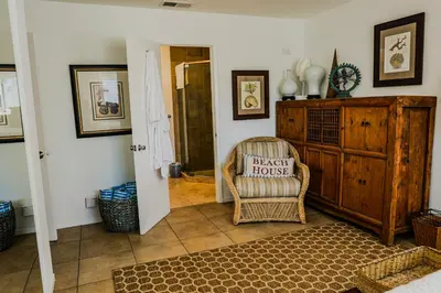 a living room with a chair and a dresser at 2 Bdr 2 bath luxury home steps away from Mission Beach 5 min from Belmont in San Diego