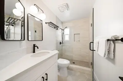 a white bathroom with a sink and a toilet at Cozy Coastal Townhome in the Heart of Pacific Beach in San Diego