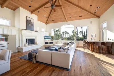 a living room with a white couch and a fireplace at ResortHome Pickle Ball Pool MovieRoom Gym Sauna Villa in Del Mar