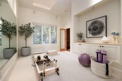 a room with a gym with a exercise ball and plants at ResortHome Pickle Ball Pool MovieRoom Gym Sauna Villa in Del Mar