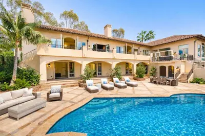 a house with a swimming pool in front of a house at ResortHome Pickle Ball Pool MovieRoom Gym Sauna Villa in Del Mar